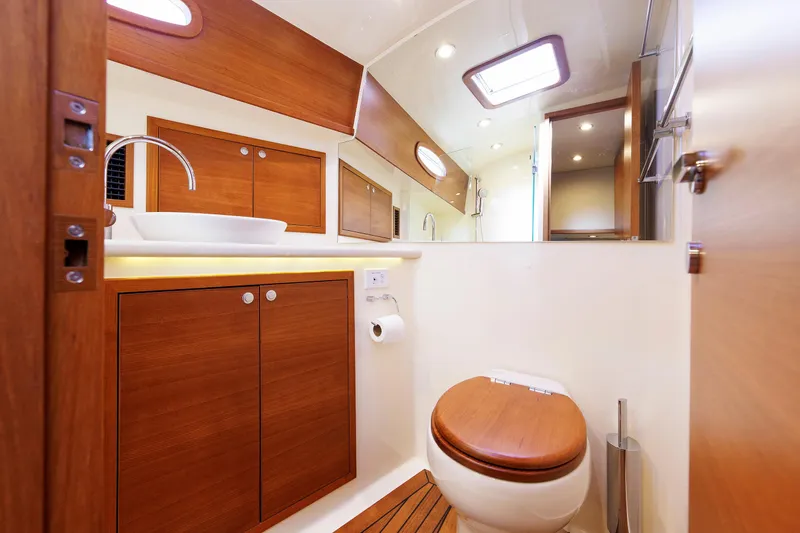 Slide: The Image of Luxurious bathroom in 2019 Grand Banks 44 Eastbay SX yacht with wooden cabinetry. - 45