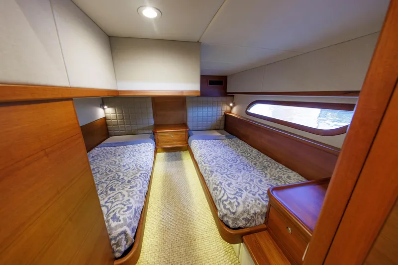 Slide: The Image of 2019 Grand Banks 44 Eastbay SX cabin with twin beds and elegant wood finish. - 49