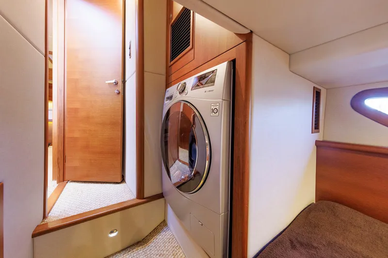 Slide: The Image of Laundry area inside 2019 Grand Banks 44 Eastbay SX yacht with modern washer. - 51