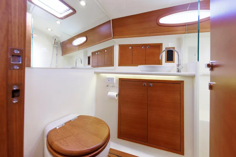 Slide: The Image of Luxurious bathroom interior of 2019 Grand Banks 44 Eastbay SX yacht, featuring wood accents and modern fixtures. - 52