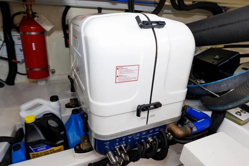 Slide: The Image of Engine room of 2019 Grand Banks 44 Eastbay SX with equipment and fire extinguisher. - 58