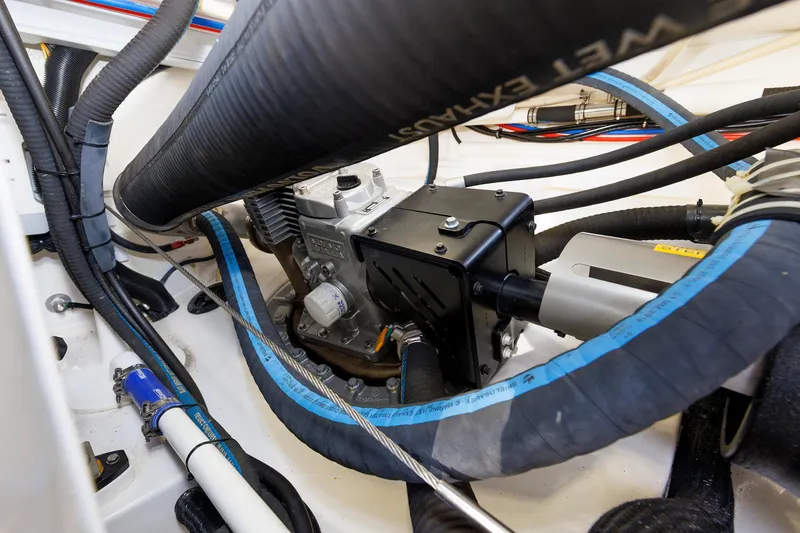 Slide: The Image of Engine compartment of 2019 Grand Banks 44 Eastbay SX with visible hoses and components. - 60