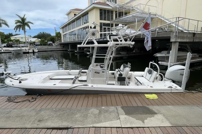 Slide: The Image of 2022 Robalo 246 Cayman SD boat docked at marina, side view. - 26
