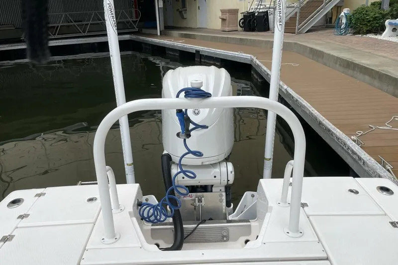 Slide: The Image of 2022 Robalo 246 Cayman SD boat with outboard motor at dock. - 31