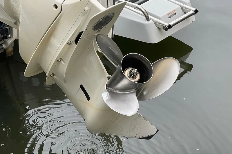 Slide: The Image of Propeller of 2022 Robalo 246 Cayman SD boat in water, close-up view. - 35