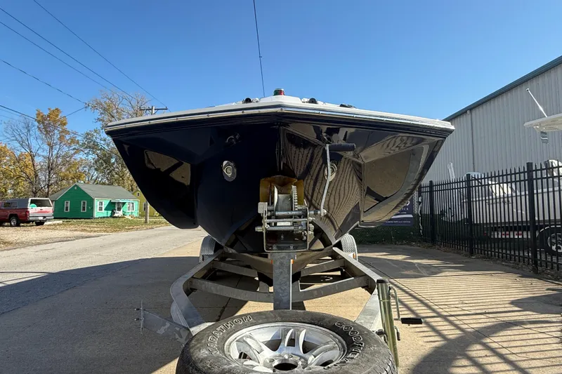 Slide: The Image of 2008 Regal 2520 FasDeck boat on trailer, parked outdoors under clear blue sky. - 12