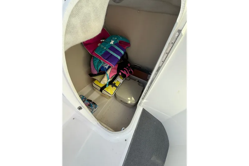 Slide: The Image of Interior storage of 2008 Regal 2520 FasDeck boat with life jackets and supplies. - 15