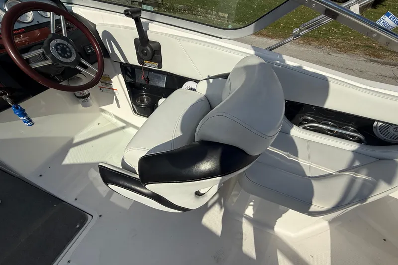 Slide: The Image of 2008 Regal 2520 FasDeck boat interior with steering wheel and white seating. - 16