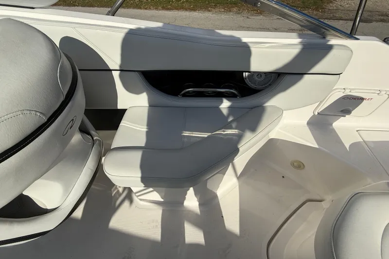 Slide: The Image of Interior of a 2008 Regal 2520 FasDeck boat with white seating and speaker. - 17