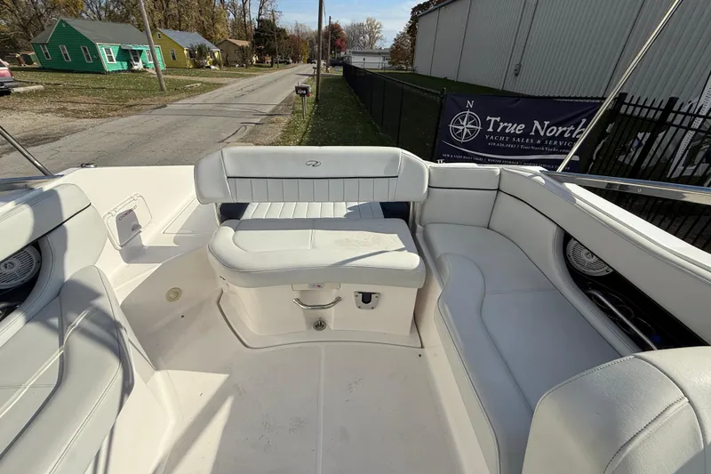 Slide: The Image of 2008 Regal 2520 FasDeck boat interior with white seating and street view. - 19