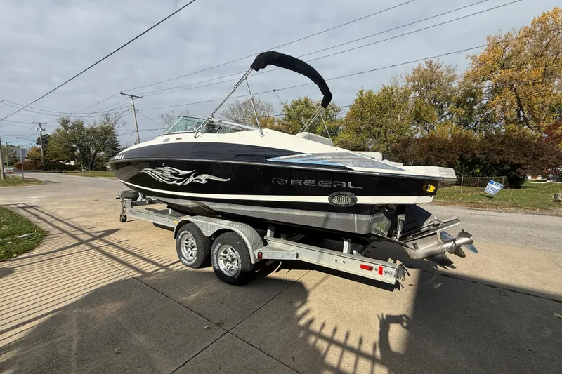 Slide: The Image of 2008 Regal 2520 FasDeck boat on trailer, parked outdoors on a sunny day. - 24