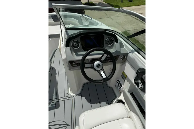 Slide: The Image of 2021 Chaparral 216 SSi boat interior with modern seating and steering wheel. - 10