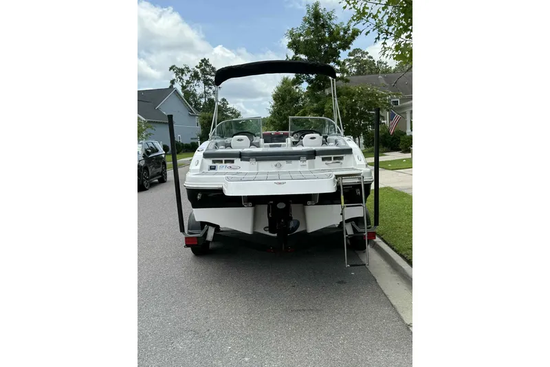 Slide: The Image of 2021 Chaparral 216 SSi boat rear view with swim platform and ladder. - 5