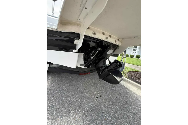 Slide: The Image of 2021 Chaparral 216 SSi boat on trailer, covered, parked on suburban street. - 7