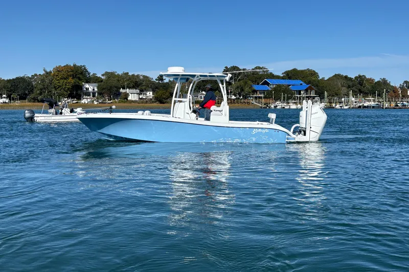 Slide: The Image of 2026 Yellowfin 26 Hybrid boat cruising on a calm blue lake. - 20