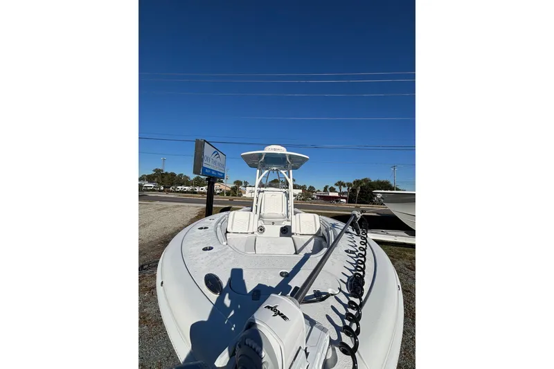 Slide: The Image of 2026 Yellowfin 26 Hybrid boat displayed outdoors under clear blue sky. - 29
