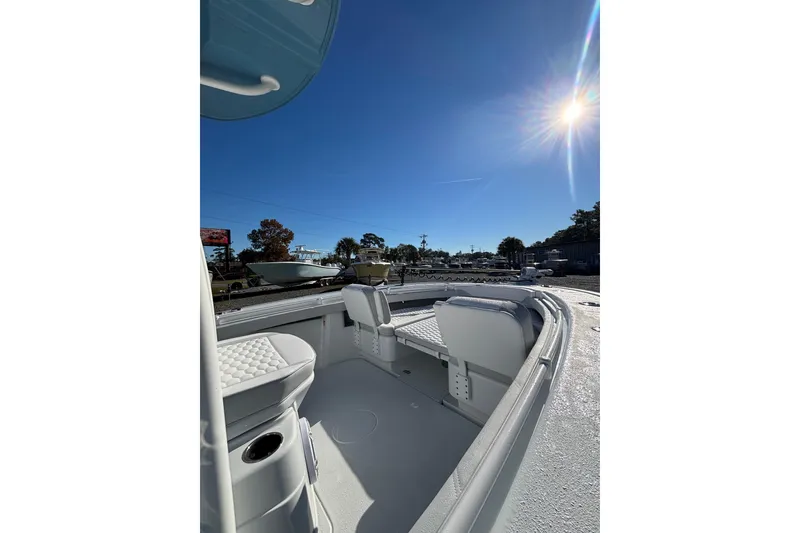 Slide: The Image of 2026 Yellowfin 26 Hybrid boat on calm water near shoreline. - 7