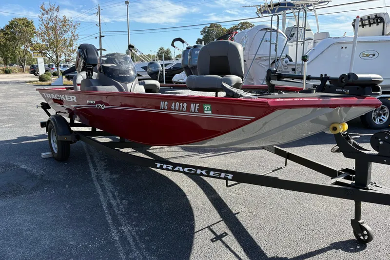 The Image of 2024 Bass Tracker Pro Team 170 boat on trailer, parked outdoors. - 0