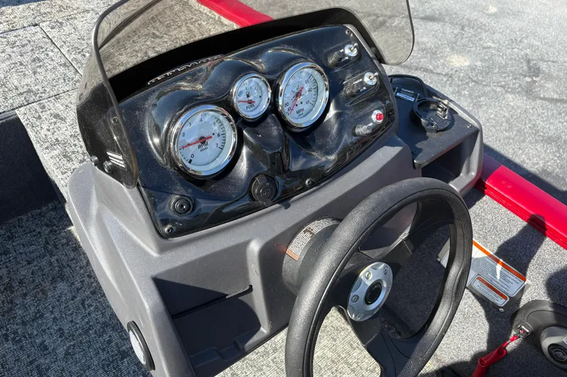 Slide: The Image of 2024 Bass Tracker Pro Team 170 dashboard with steering wheel and gauges. - 13