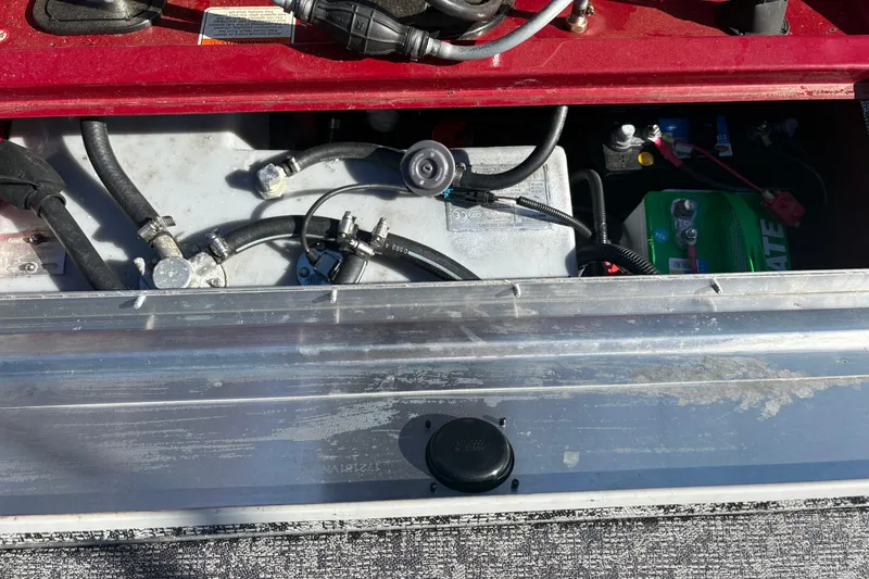 Slide: The Image of 2024 Bass Tracker Pro Team 170 boat battery compartment with wiring and components. - 10