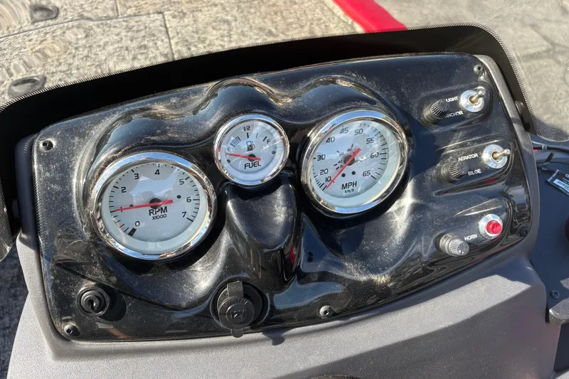 Slide: The Image of Dashboard of 2024 Bass Tracker Pro Team 170 boat with gauges and switches. - 12