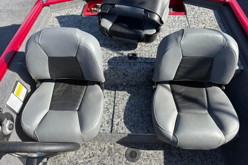Slide: The Image of 2024 Bass Tracker Pro Team 170 boat interior with gray seats and red accents. - 14