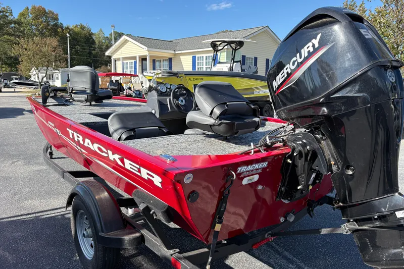 Slide: The Image of 2024 Bass Tracker Pro Team 170 boat with Mercury engine, parked outdoors. - 4