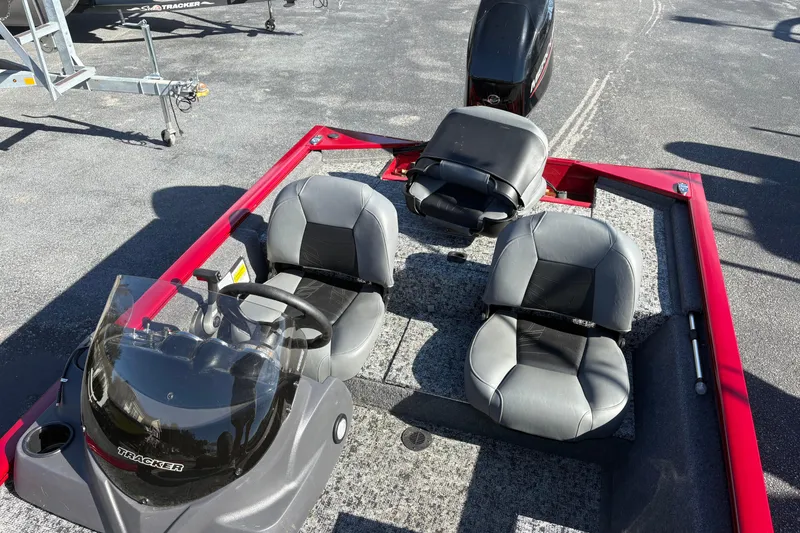 Slide: The Image of 2024 Bass Tracker Pro Team 170 boat interior with seating and steering console. - 5