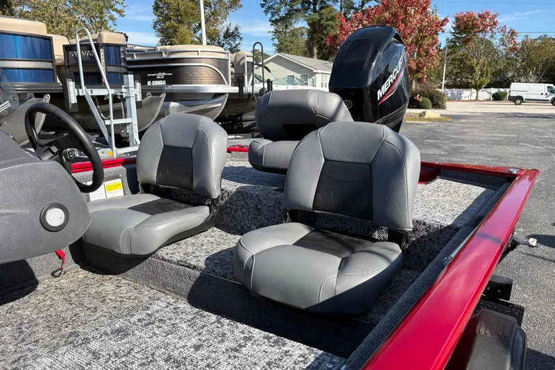 Slide: The Image of 2024 Bass Tracker Pro Team 170 boat interior with gray seats and Mercury engine. - 6