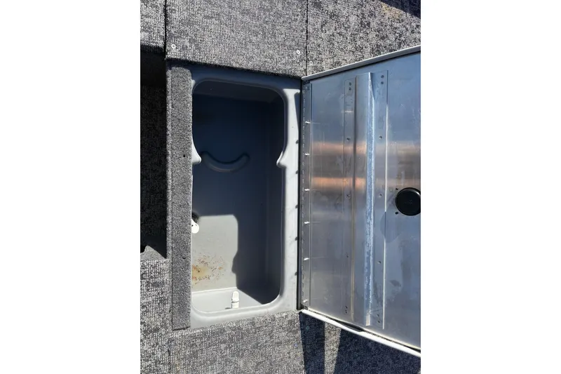 Slide: The Image of Open storage compartment in 2024 Bass Tracker Pro Team 170 boat. - 8