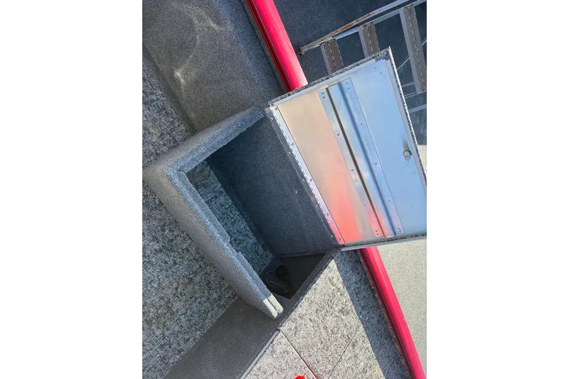 Slide: The Image of 2024 Bass Tracker Pro Team 170 boat interior with open storage compartment. - 9