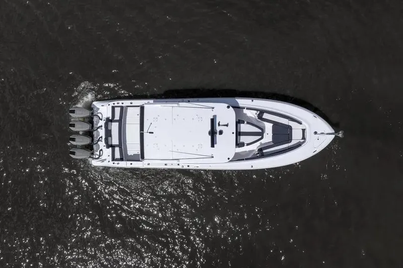 Slide: The Image of Aerial view of 2024 HCB 42 Lujo boat cruising on dark water. - 10