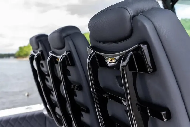 Slide: The Image of Luxury seating on the 2024 HCB 42 Lujo boat, featuring sleek black design. - 19