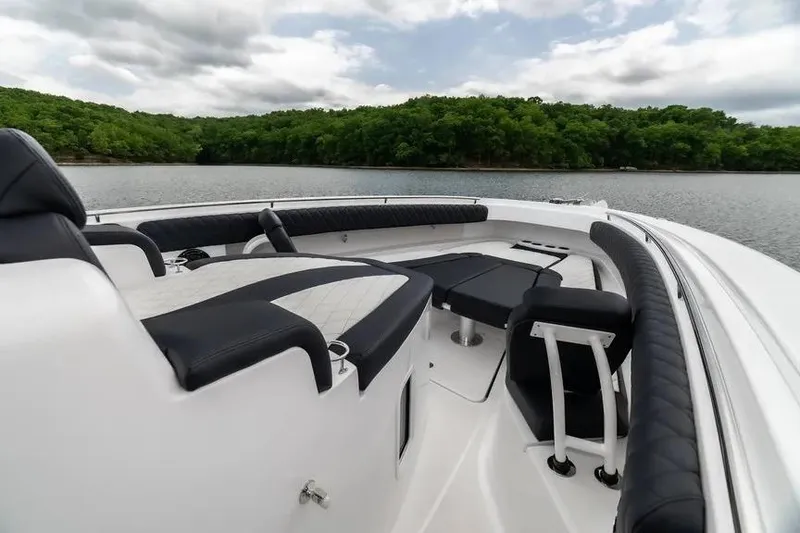 Slide: The Image of 2024 HCB 42 Lujo boat interior with luxurious seating on a serene lake. - 30