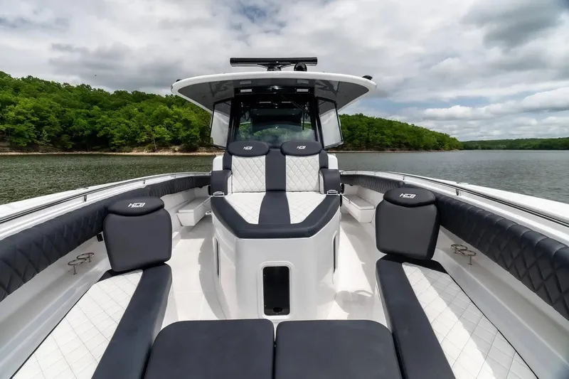 Slide: The Image of 2024 HCB 42 Lujo boat interior with luxurious seating on a serene lake. - 31