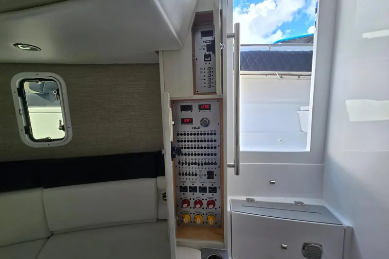 Slide: The Image of Interior view of 2024 HCB 42 Lujo boat, featuring control panel and seating area. - 36