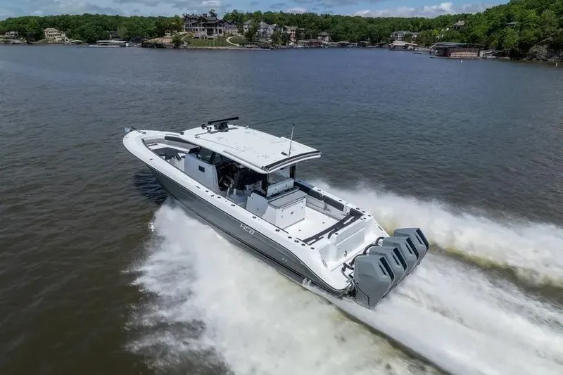 Slide: The Image of 2024 HCB 42 Lujo boat cruising on a lake with powerful engines. - 4