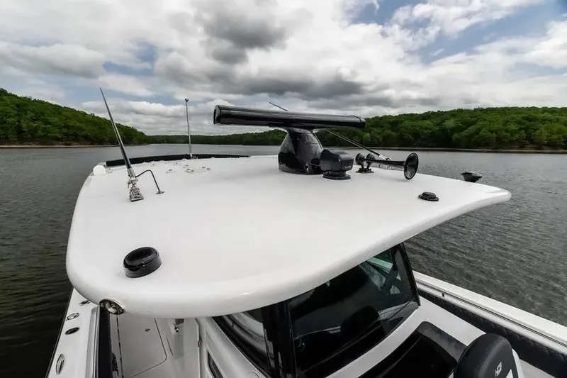 Slide: The Image of 2024 HCB 42 Lujo boat on a lake with lush green shoreline. - 40