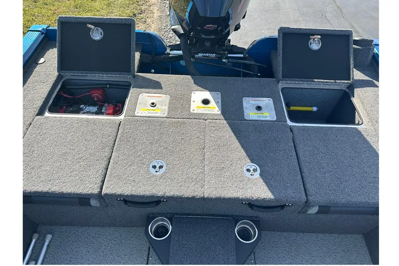 Slide: The Image of 2024 Lund 2075 Pro-V Bass XS boat storage compartments and engine view. - 13