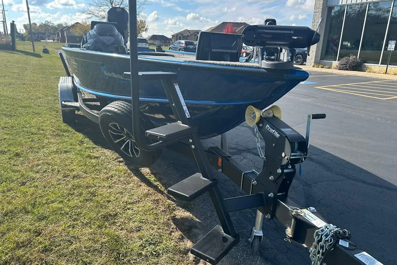 Slide: The Image of 2024 Lund 2075 Pro-V Bass XS boat on trailer, parked outdoors. - 29