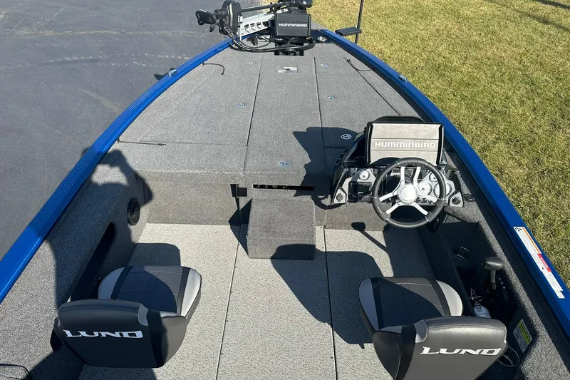 Slide: The Image of 2024 Lund 2075 Pro-V Bass XS boat interior with steering console and seating. - 6