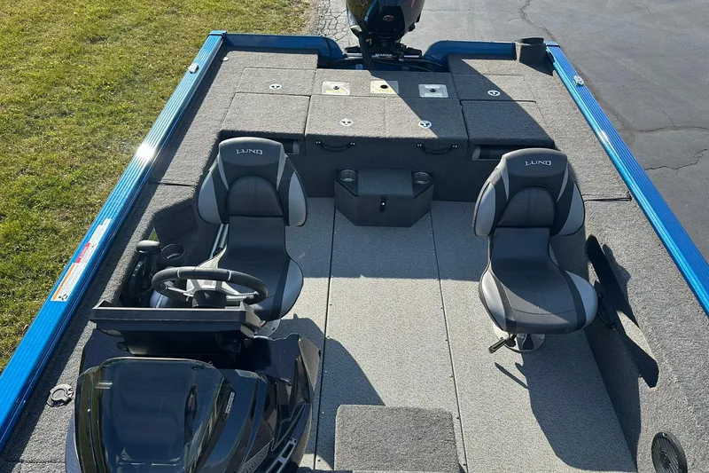 Slide: The Image of 2024 Lund 2075 Pro-V Bass XS boat interior with seating and steering console. - 8