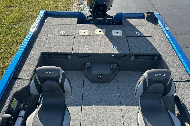 Slide: The Image of 2024 Lund 2075 Pro-V Bass XS boat interior with seating and storage compartments. - 9
