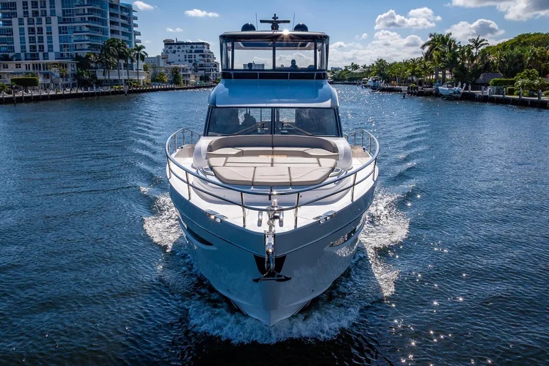 Slide: The Image of Luxurious 2023 Princess Y72 yacht cruising on a sunny day in a scenic waterway. - 10