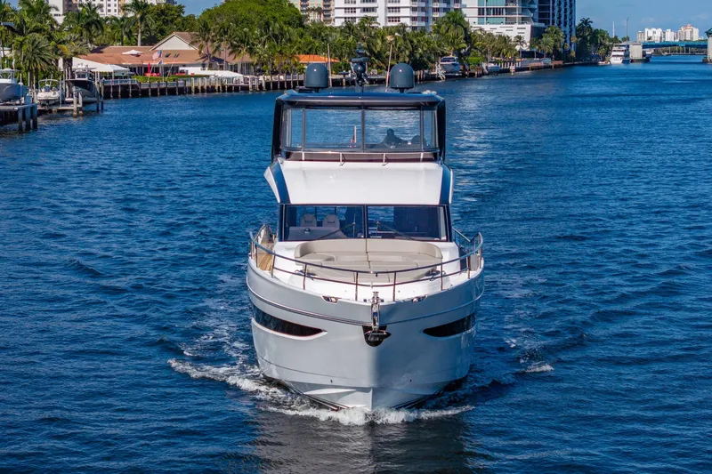 Slide: The Image of Luxury 2023 Princess Y72 yacht cruising on a scenic waterway. - 11