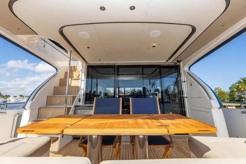 Slide: The Image of Luxurious 2023 Princess Y72 yacht interior with elegant wooden table and seating. - 16