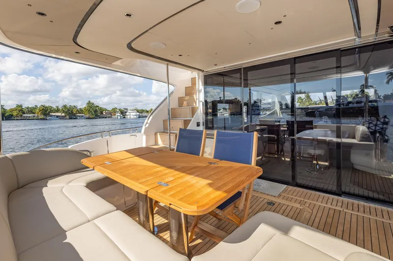 Slide: The Image of Luxurious 2023 Princess Y72 yacht deck with elegant seating and dining area. - 17