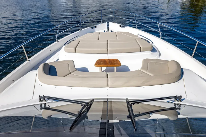 Slide: The Image of Luxurious 2023 Princess Y72 yacht deck with cushioned seating and table on calm water. - 24