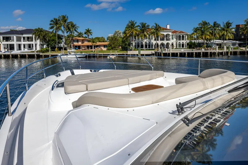 Slide: The Image of Luxury yacht Princess Y72, 2023 model, cruising near waterfront mansions and palm trees. - 26