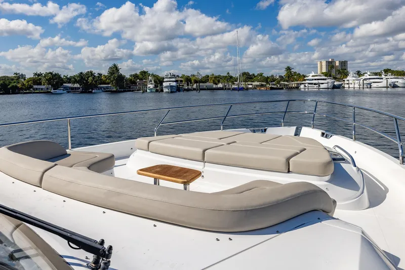 Slide: The Image of Luxurious 2023 Princess Y72 yacht deck with plush seating, overlooking serene waterfront. - 27
